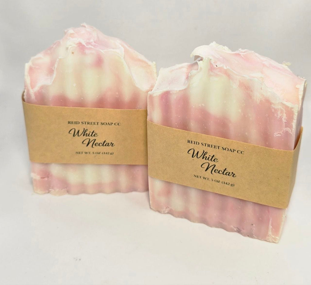 Two bars of soap labeled 'White Nectar' from Reid Street Soap Co on a light gray background.
