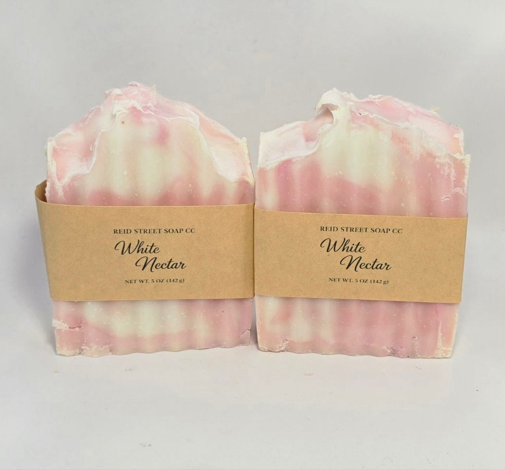 Two bars of soap with 'White Nectar' packaging on a light gray background
