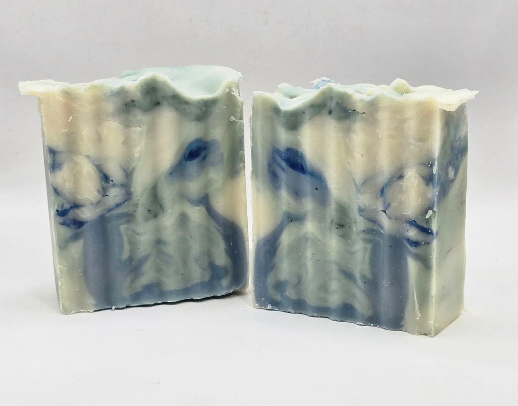 Two bars of soap with blue and white marbled pattern on a light gray background