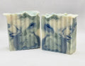 Two bars of soap with blue and white marbled pattern on a light gray background